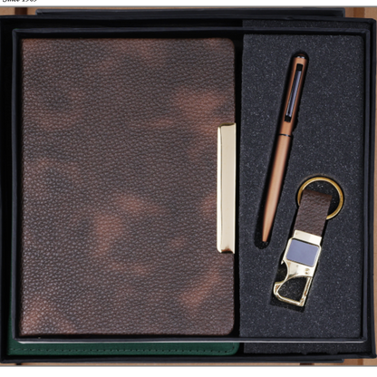 A Jalani Diary gift set in a black presentation box, featuring a brown textured leather notebook, a matching brown pen, and a leather keychain with gold-tone hardware, shown on a white background with the Jalani Diary logo and product number 2026526.
